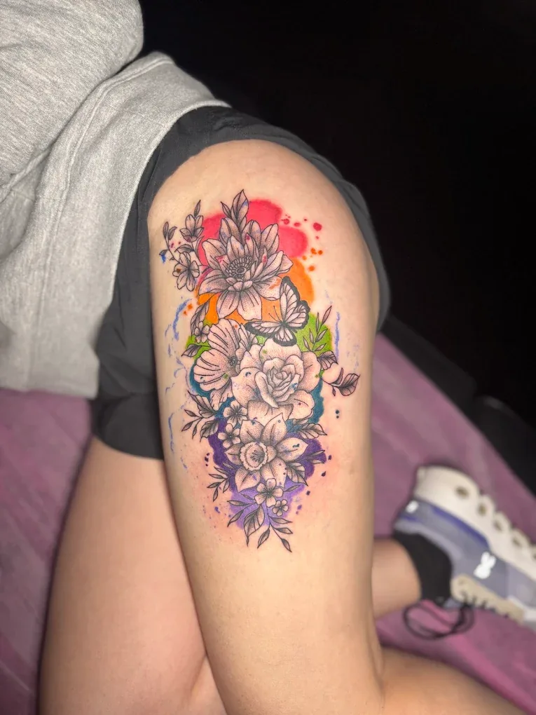 Floral tattoo with watercolor accents from Wyatt Tattoo LLC